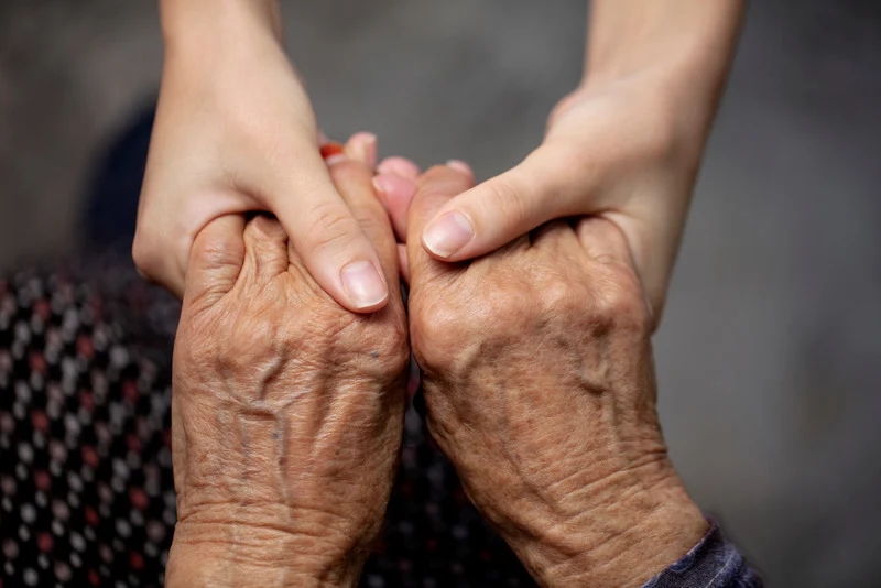 Caring hands holding elderly hands, sharing warmth and connection